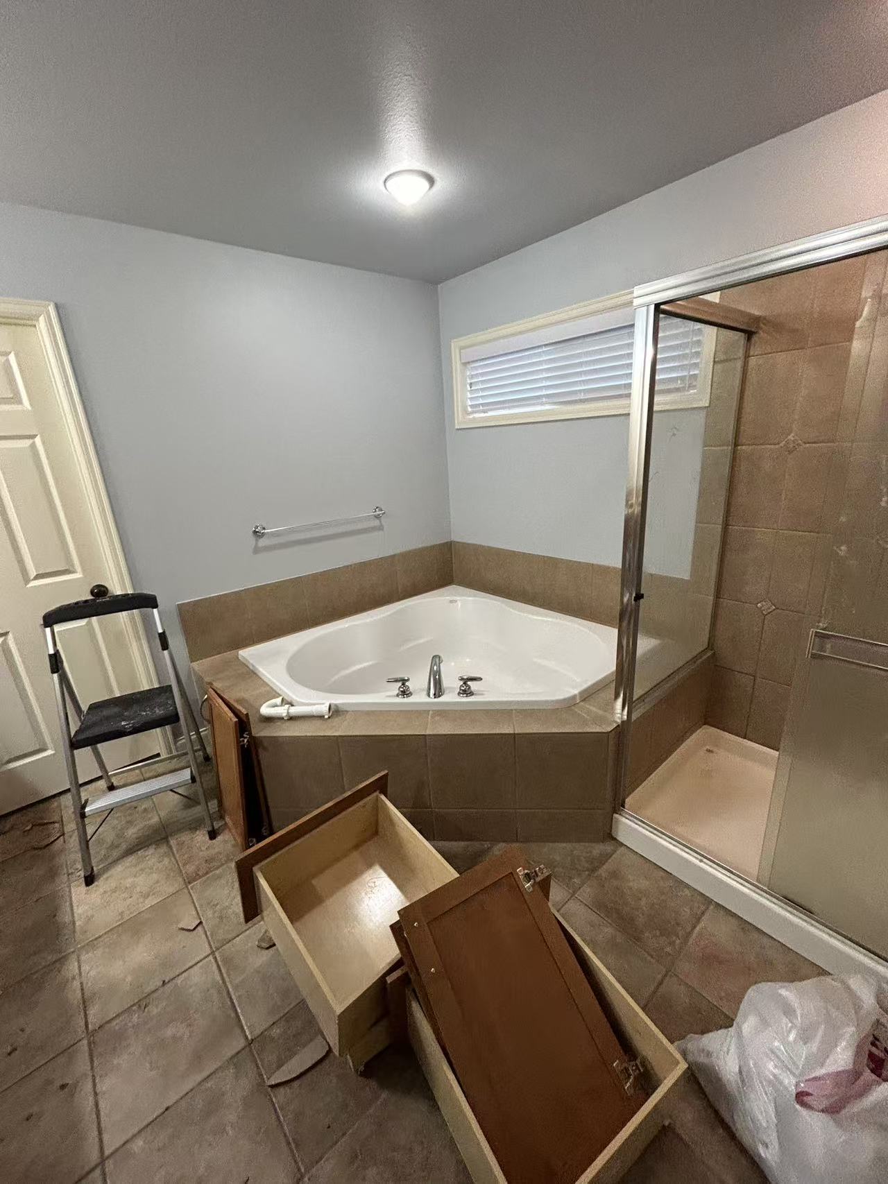 Bothell master bath renovation — before, corner tub with dated brown tile
