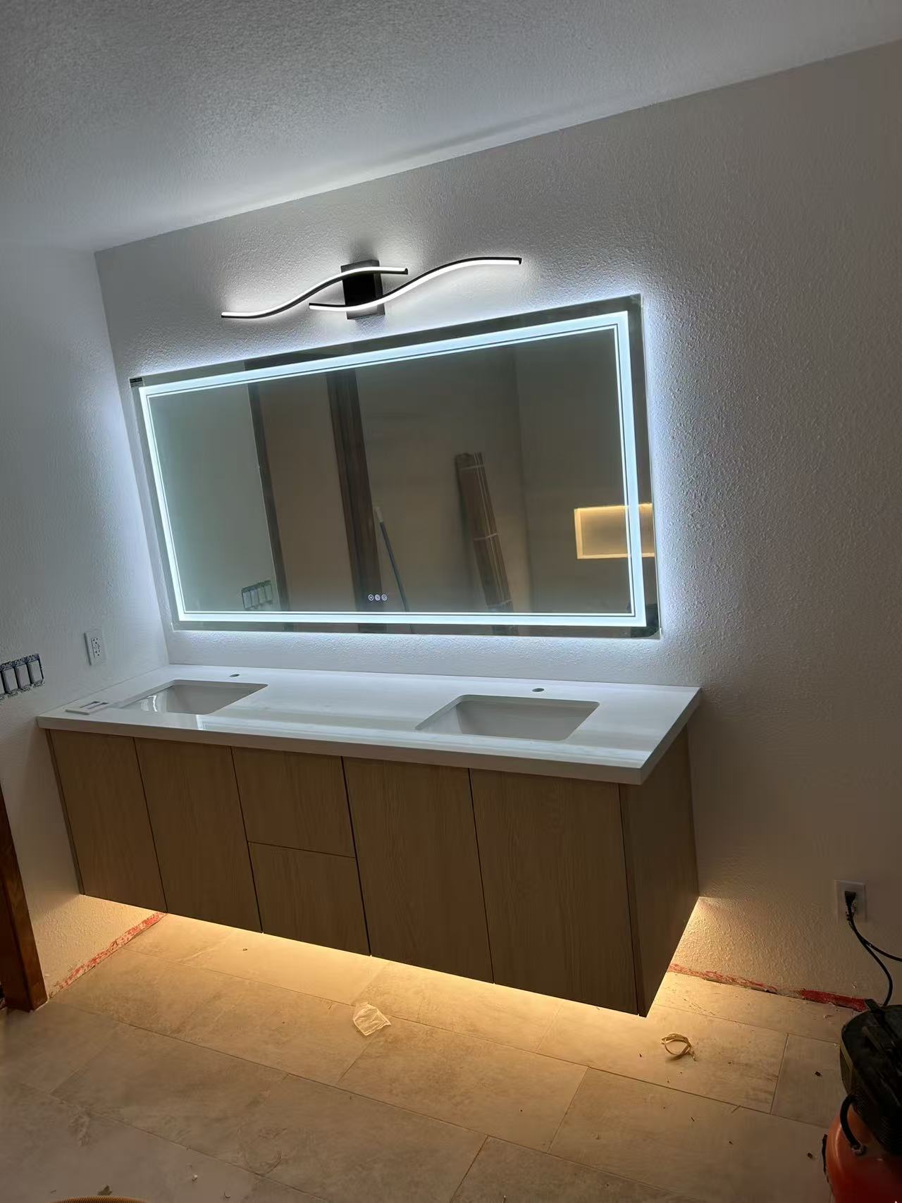 Bellevue spa bath stage 6 — finished floating wood vanity with backlit LED mirror