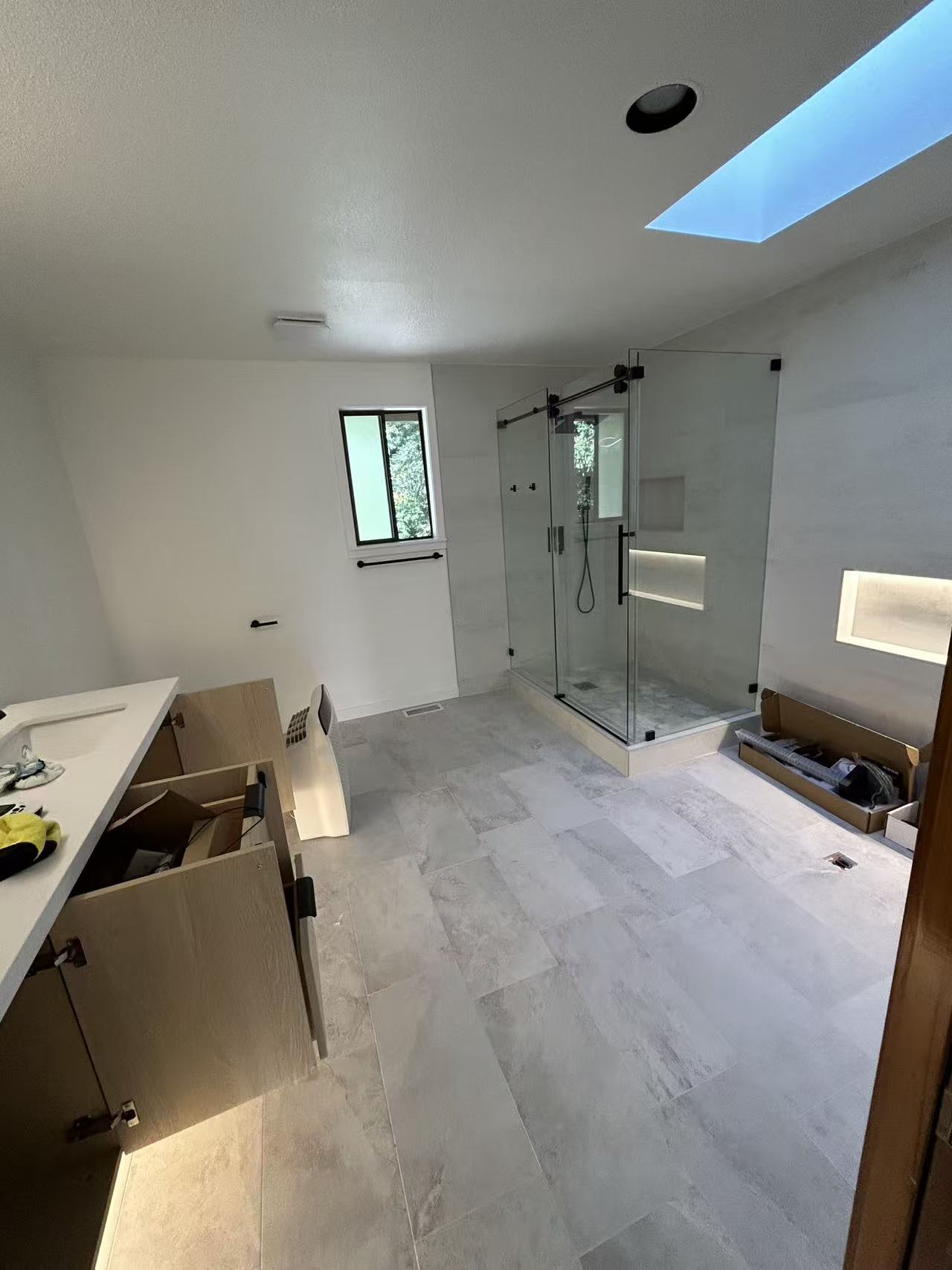 Bellevue spa bath renovation — after, frameless glass walk-in shower with floating wood vanity