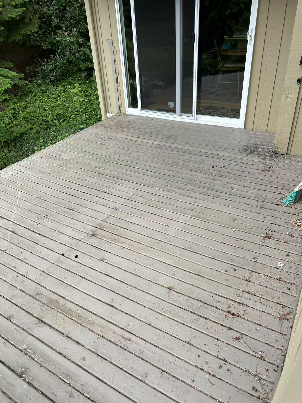 Bothell deck renovation — before, weathered gray boards with worn finish